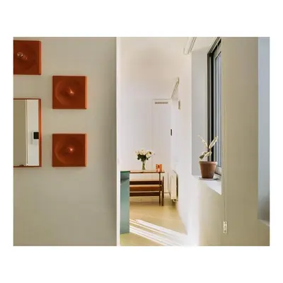 a hallway with a mirror and a room with a table at Garden flat in central brussels in Brussels