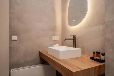a bathroom with a white sink and a mirror at BelGem in Antwerp