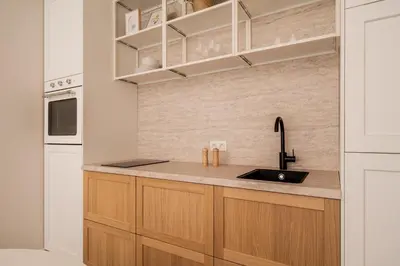 a kitchen with wooden cabinets and a sink at BelGem in Antwerp
