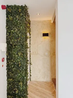 a room with a wall covered in ivy at SAFIR by Domani Hotels in Aalst