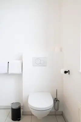 a white bathroom with a white toilet in it at SAFIR by Domani Hotels in Aalst