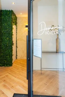a glass door with a sign in a room at SAFIR by Domani Hotels in Aalst