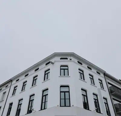 a white building with windows on top of it at SAFIR by Domani Hotels in Aalst