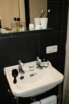 a white sink in a bathroom with a mirror at Studio Lido by Simone Antwerp in Antwerp