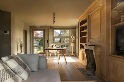 a living room with a couch and a fireplace at Waterfront vacation home in Sint-Amands