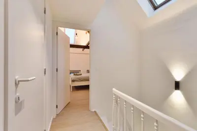 a hallway with a stairway leading to a bedroom at Luxury escape in the heart of historic Mechelen in Mechelen