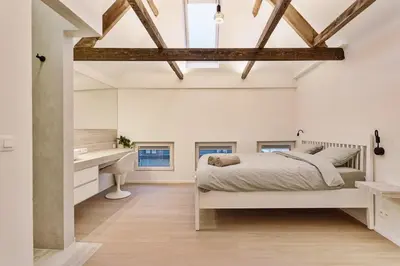 a bedroom with a bed and a desk at Luxury escape in the heart of historic Mechelen in Mechelen