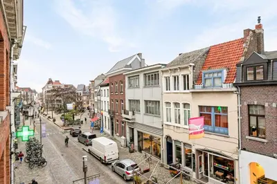 a city street with buildings and cars on the street at Luxury escape in the heart of historic Mechelen in Mechelen