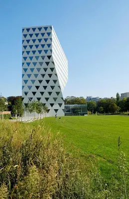 a building with a green field in front of it at Cosy and Fully Equipped Studio in Antwerp
