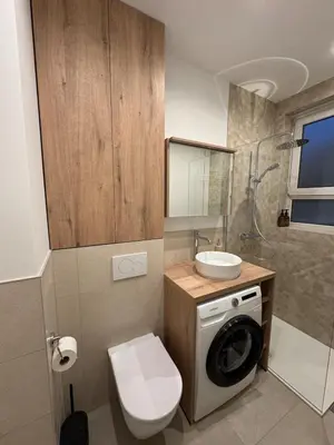 a bathroom with a washing machine and a sink at Cosy and Fully Equipped Studio in Antwerp