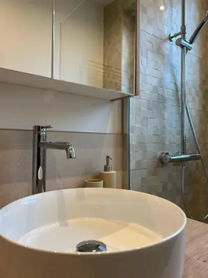 a white sink in a bathroom with a shower at Cosy and Fully Equipped Studio in Antwerp