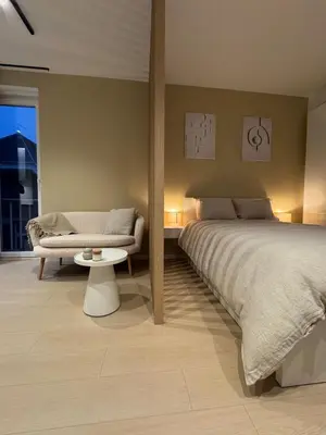 a bedroom with a large bed and a couch at Cosy and Fully Equipped Studio in Antwerp