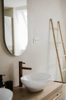 a bathroom with a white bowl sink on a wooden counter at Apartment in the House of the Harbor Captain in Antwerp