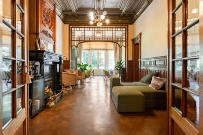 a living room with a couch and a fireplace at Boutique Baron Osy Suite Second Street in Antwerp