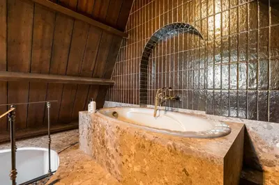 a bathroom with a sink and a bath tub at Boutique Baron Osy Suite Second Street in Antwerp