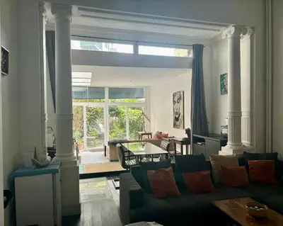 a living room with a couch and a table at Art Apartment in Brussels