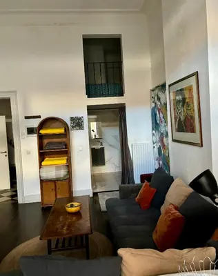 a living room with a couch and a table at Art Apartment in Brussels