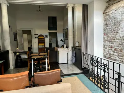 a living room with a balcony with a table and chairs at Art Apartment in Brussels