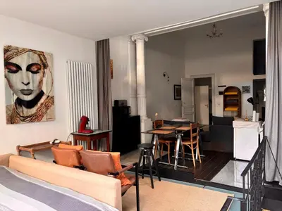 a living room with a couch and a table at Art Apartment in Brussels