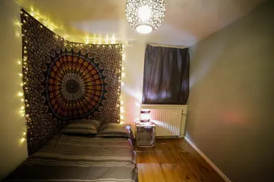 a bedroom with a bed with a decorative wall at Bruxelles centre petite chambre privée au Sablon ! in Brussels
