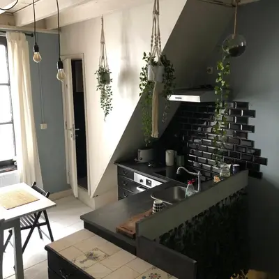 a kitchen with a black counter top and a stove at Bruxelles centre petite chambre privée au Sablon ! in Brussels