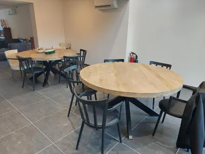 a dining room with two wooden tables and chairs at Krie1 by Luttelkolen in Tielt