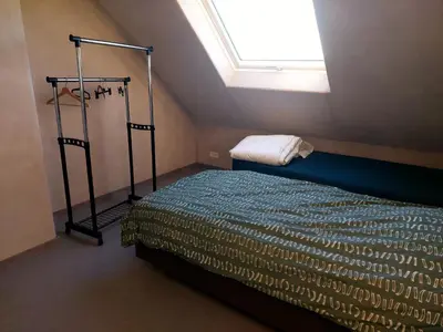 a bedroom with a bed and a skylight at Krie1 by Luttelkolen in Tielt