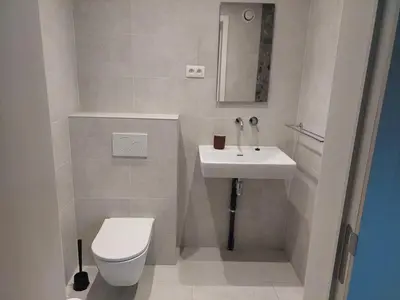 a small bathroom with a toilet and a sink at Krie1 by Luttelkolen in Tielt