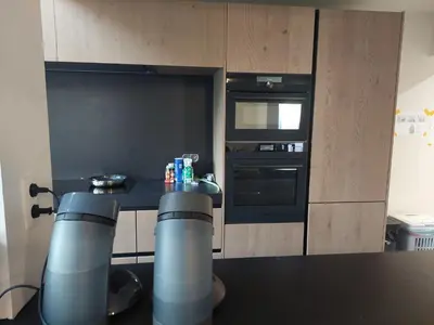 a small kitchen with a table and an oven at Krie1 by Luttelkolen in Tielt