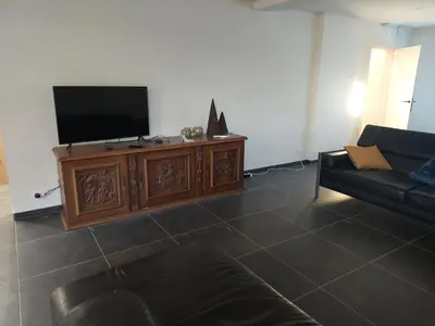 a living room with a television and a couch at Krie1 by Luttelkolen in Tielt
