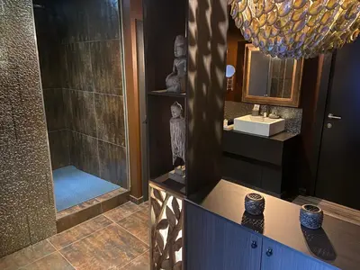 a bathroom with a shower and a sink at Escape to Unwind in Putte