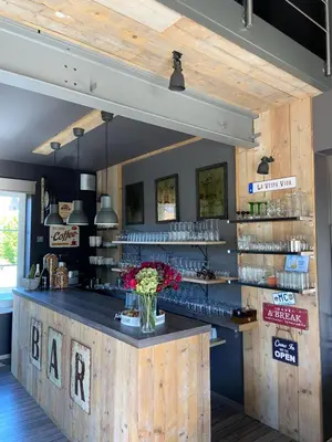 a bar with a wooden counter in a restaurant at Escape to Unwind in Putte