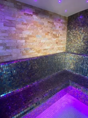 a bath tub with purple lights in a room at Escape to Unwind in Putte