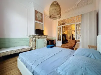 a bedroom with a large bed and a fireplace at Bruxelles Midi in Brussels