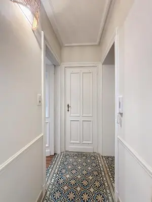 a hallway with a white door and a tile floor at Bruxelles Midi in Brussels