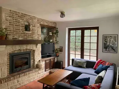 a living room with a couch and a fireplace at Wahwo Baki in Wachtebeke