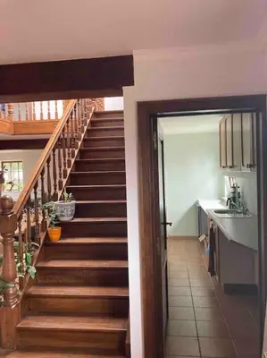 a hallway with a staircase in a home with a kitchen at Wahwo Baki in Wachtebeke