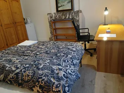 a bedroom with a bed and a desk and a desk at Bloemetje in Asse