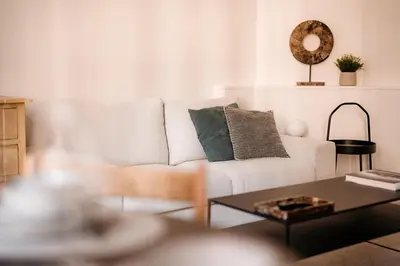 a living room with a white couch and a table at Cathedral View luxurious Apartment in Antwerp