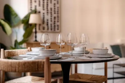 a table with wine glasses and plates on it at Cathedral View luxurious Apartment in Antwerp