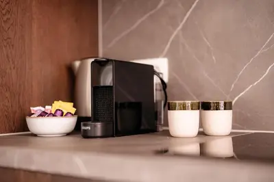 a kitchen counter with a microwave and two cups at Cathedral View luxurious Apartment in Antwerp
