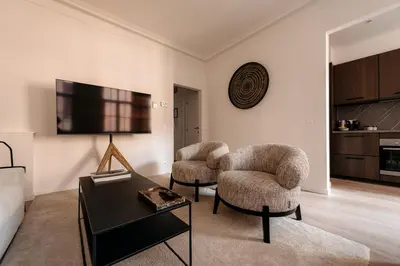 a living room with two chairs and a table at Cathedral View luxurious Apartment in Antwerp