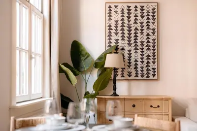 a room with a table with a lamp and a plant at Cathedral View luxurious Apartment in Antwerp