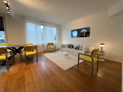 a living room with a white couch and a table at Plein centre de Waterloo! 1 in Waterloo