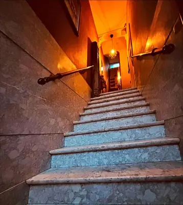 a set of stairs in a building with a light on at Room in Guest room - Charming Guest Room in Historic Brussels Mansion in Brussels