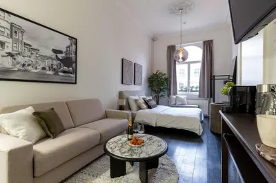 a living room with a couch and a bed at Museum Suites in Antwerp