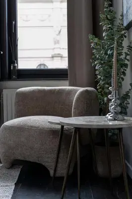 a living room with a couch and a table at Museum Suites in Antwerp