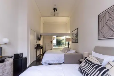 a living room with two beds and a couch at Museum Suites in Antwerp