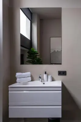a bathroom with a white sink and a mirror at Museum Suites in Antwerp