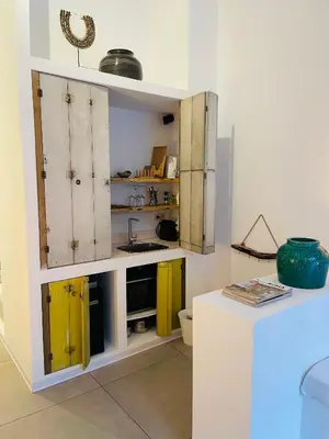 a kitchen with yellow cabinets and a sink at Oscarsleeps in Ghent